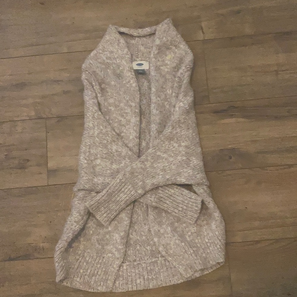 A cardigan colored cream/tan.